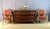 A Louis XVI commode with brass moldings, opening with five drawers: three in the upper section and two larger drawers...