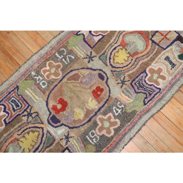 A 20th-century American hooked colorful rug. Dated 1949 Measures: 2'7'' x 5'6''.
