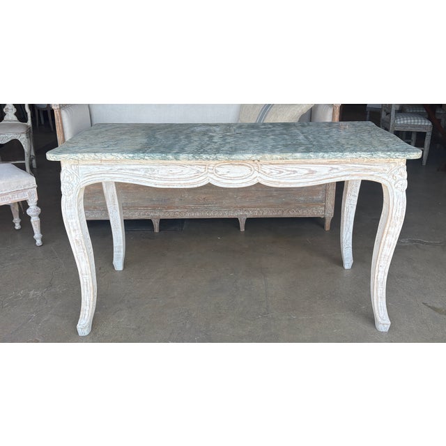 Wonderful Louis XV style console table with carved frame paired with a stunning marble top. The console table originated...