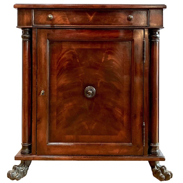 Magnificent pair of unique circa 1990's Regency Empire Mahogany nightstands. Each features four cast metal lions paw feet...