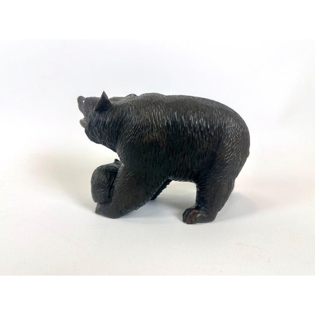 The hand-carved figurine has glass eyes and complete teeth. The state of preservation is surprisingly good.