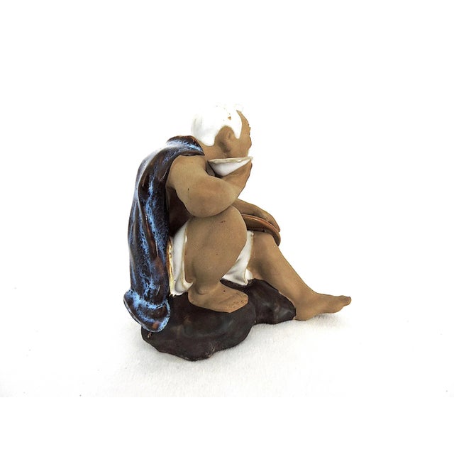 1980's fine Shiwan figure of an elderly white haired man perched on a rock with his wicker hat and drinking cup - probably...