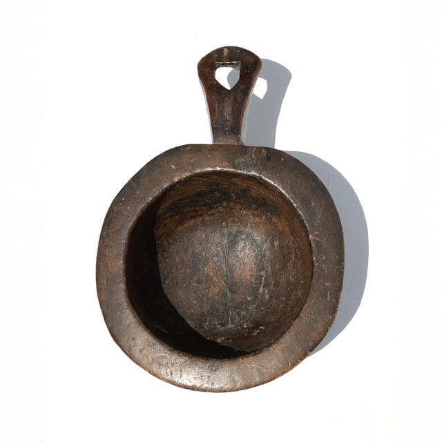 Turned chestnut bowl with integral handle. Hand-turned from a single piece of wood. The handle terminates in a pierced...