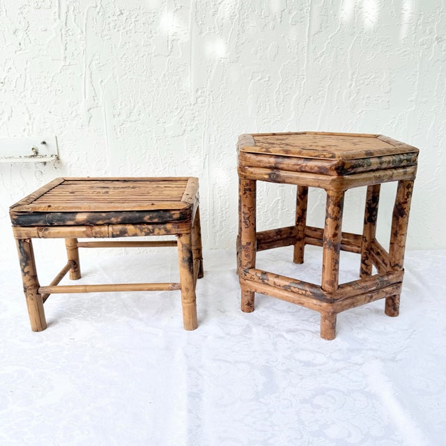 A charming pair of vintage bamboo accent tables featuring a richly mottled burnt tortoise shell finish that highlights the...