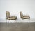 Late modern lounge chairs combining clear lucite arms and legs with polished metal framing and graphic woodgrain-patterned...