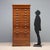 Art Nouveau oak filing cabinet. The front features 18 drawers with drop-fronts, arranged on two columns and equipped with...