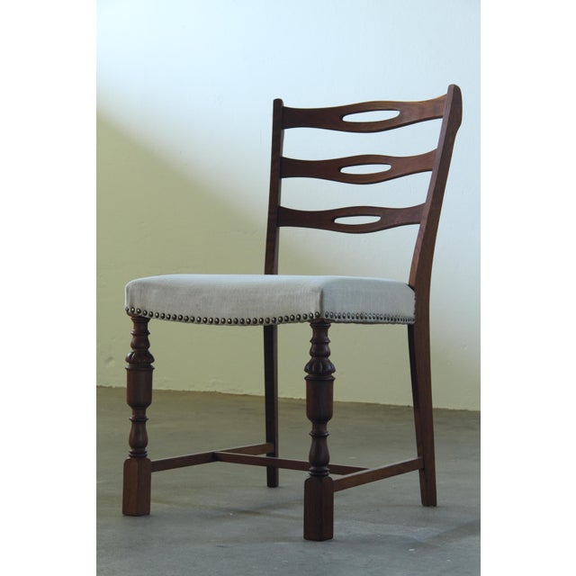 Set of six Danish dining chairs in dark stained oak, 1960s. A strong and balanced design with a clear mix of styles. The...