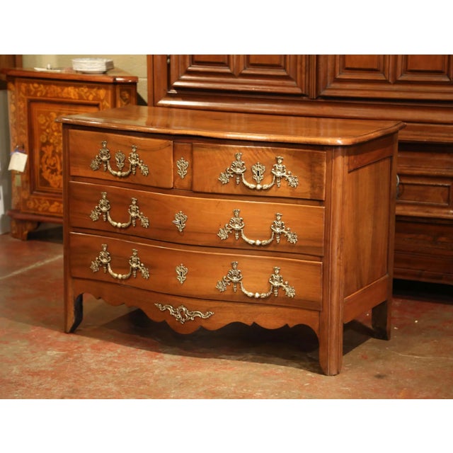 This traditional, antique chest of drawers was crafted in the Poitou region of France, circa 1800. The fruit wood commode...