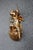Carved giltwood wall bracket featuring a winged cherub seated atop a fluted pedestal. Richly detailed with a distressed...