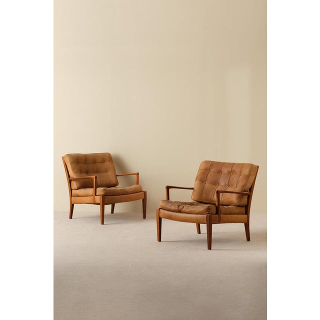 Easy chairs model Loven designed by Arne Norell. Produced by Arne Norell AB in Aneby, Sweden, 1960s. Original cognac...