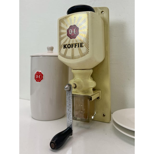 A Dutch wall-mounted coffee grinder from the well-known brand Douwe Egberts. The grinder is made of ceramic, cast iron and...