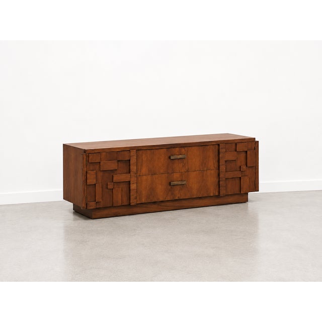 An authentic 1960s Lane Staccato credenza showcasing one of the most recognizable Brutalist designs of the era. Rich...