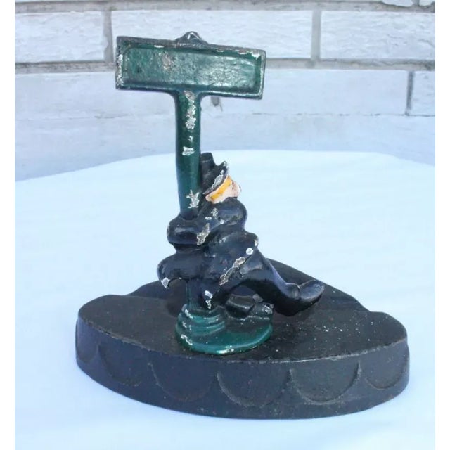 Antique cast iron ashtray made by Wilton Prod. Wrightsville, PA featuring a gentleman hanging onto a post with a sign that...