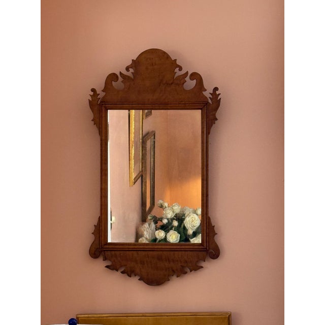 A charming 19th-century American wall mirror crafted in beautifully figured maple, dating to approximately 1840–1860. The...