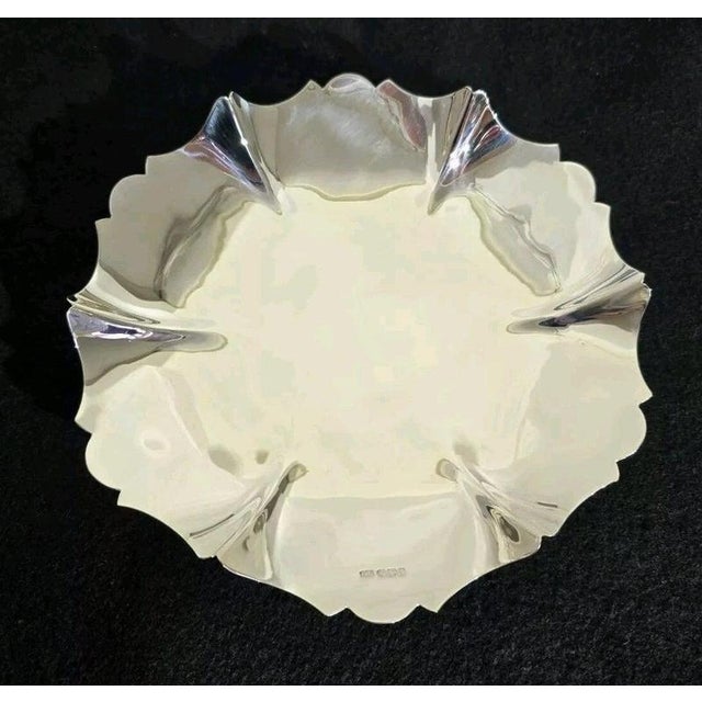 A fine George VI sterling silver cake stand, fruit dish or tazza dating to 1936, displaying an elegant and understated...