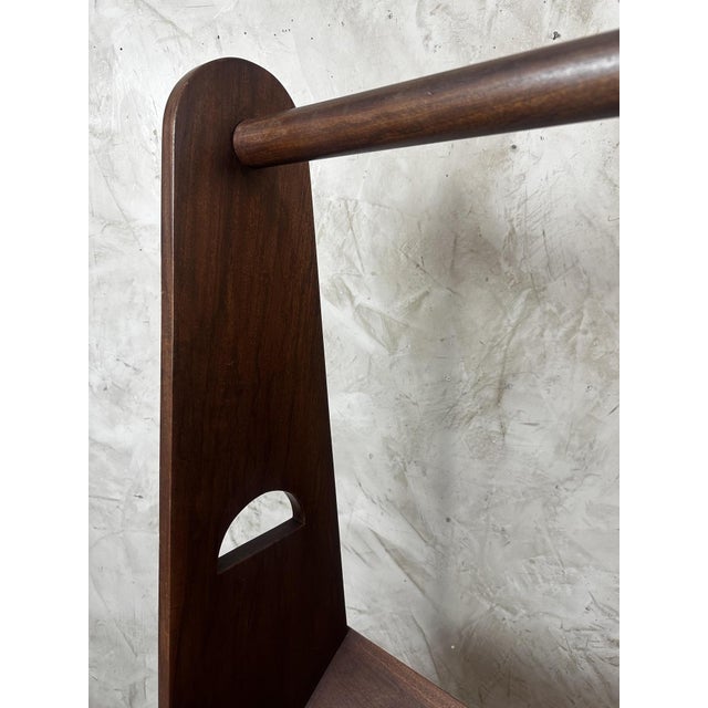 An elegant walnut coat rack dating from the 1960s, with clean lines typical of Scandinavian design and post-war modernism....