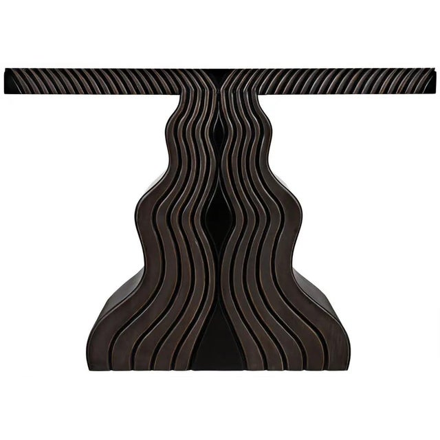 Undulating carvings that recollect open hands and old growth forests cover the waved base, as well as the edges of the...