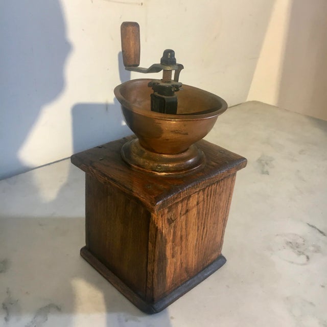 French-style coffee grinder/mill with wood body and copper hopper. Appears to be in working order. Oxidation to metal,...