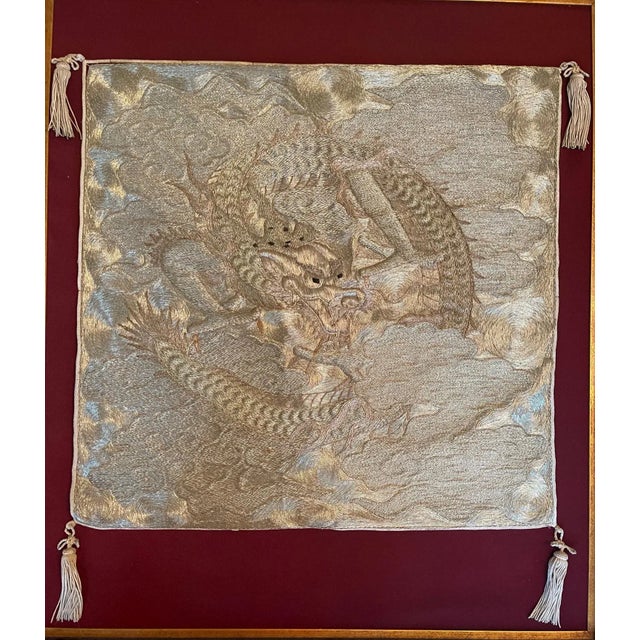 A visually stunning Japanese fukusa panel with an embroidered dragon on a swirling cloud background, nicely displayed on a...