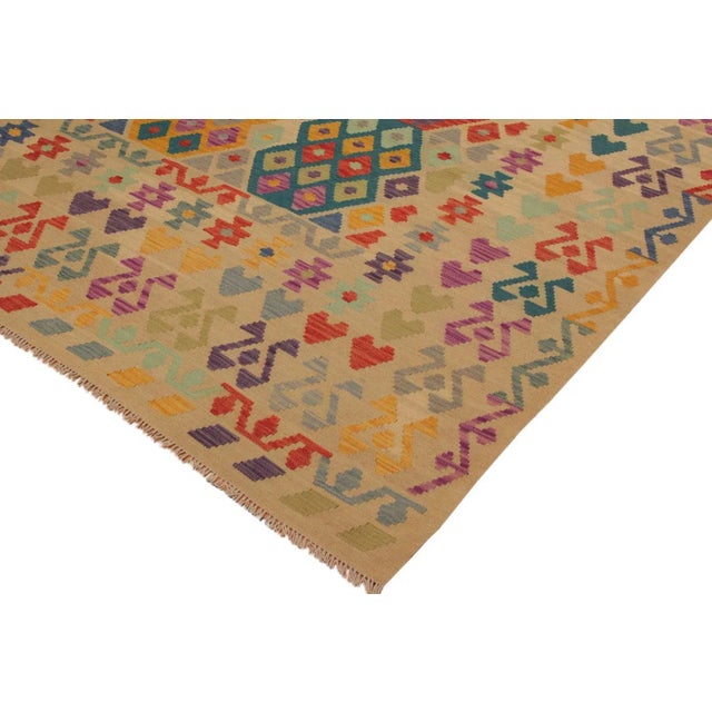Add a touch of elegance to your home with this casual chic hand woven Tribal Kilim wool rug. Constructed on a loom by...