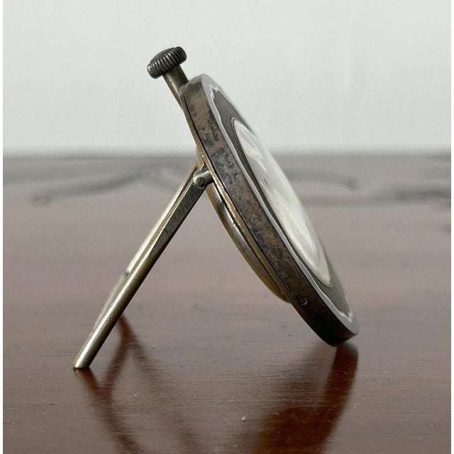 Cyma - Art Deco Table Clock with Enamels, 1920s-1930s Shaped gilded metal case with blue, black, and white enamel edges....