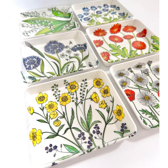 A charming set of six vintage Made in Italy melamine trays featuring vibrant botanical illustrations of spring...