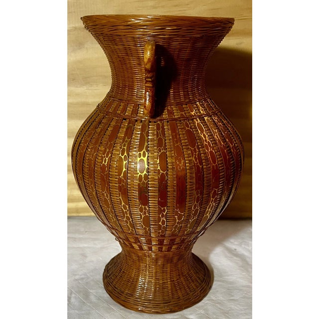Add a touch of Mid-Century Modern charm to your home with this **Vintage Japanese Wicker Vase**, standing approximately...
