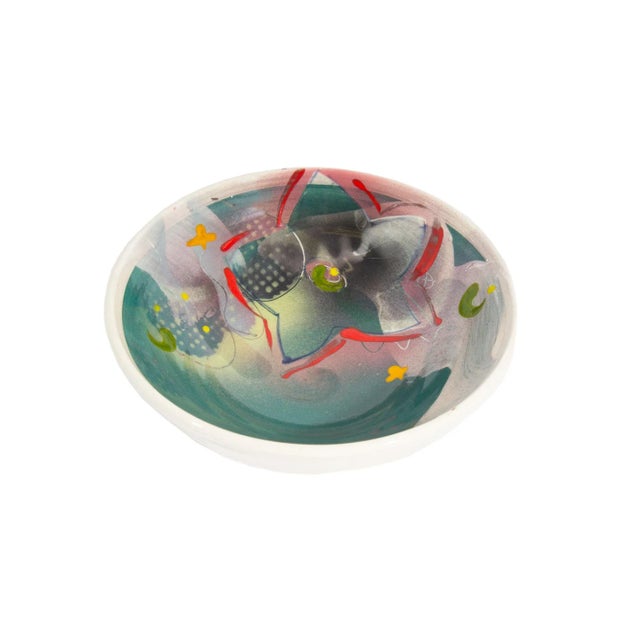 A Postmodern studio pottery bowl by the American artist Madeline Kaczmarczyk. This bowl has a colorful floral pattern in...