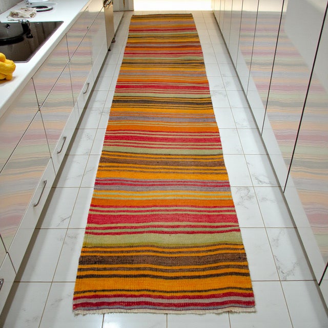 Woven in the Oushak region of Western Türkiye in the 1960s, this vintage Turkish kilim runner brings an uplifting, folk-...