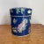 Lovely Asian ceramic canister with moth and peach motif. Bluish purple background with pink, green and yellow accents....