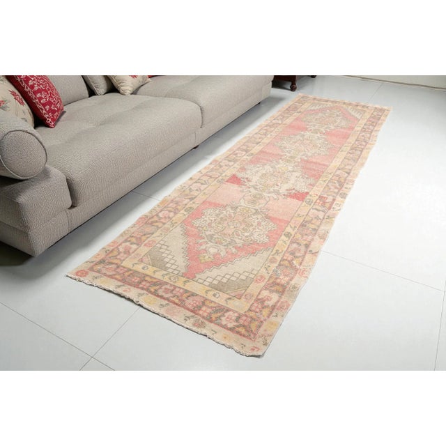 This is a vintage Turkish Oushak rug from the 1960s. The piece was hand-knotted.