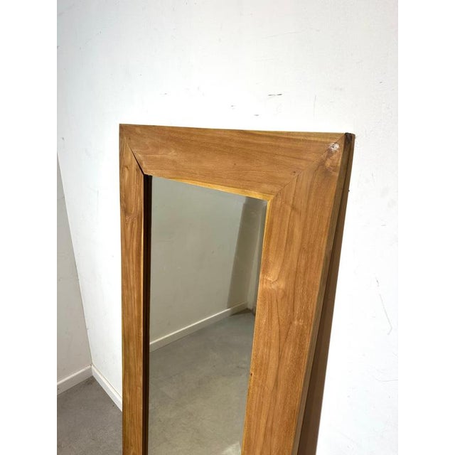 Beautiful large mirror with a solid wooden frame in a warm natural tone. Its clean lines and slightly angled frame give it...