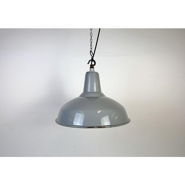 Industrial grey enamel factory pendant light made in United Kingdom during the 1960s. White enamel inside the shade. Iron...