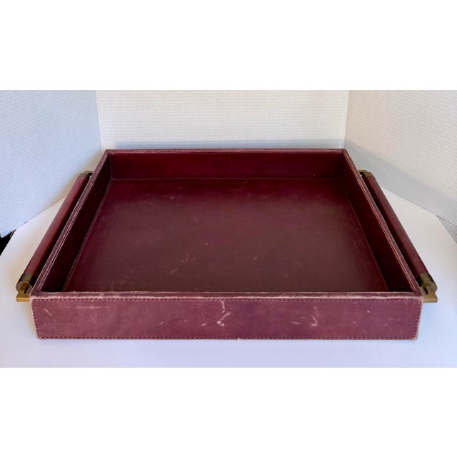 This large leather serving tray by Global Views was produced in the late 20th century, likely 1990s, and features a rich...