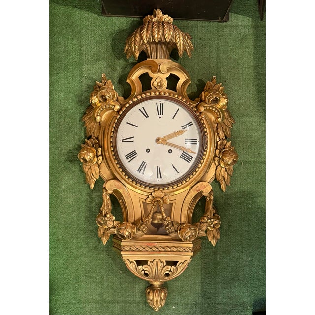This listing is for a large Swedish wall clock. This clock was made in the Gustavian style with a gilt wood cartel frame....