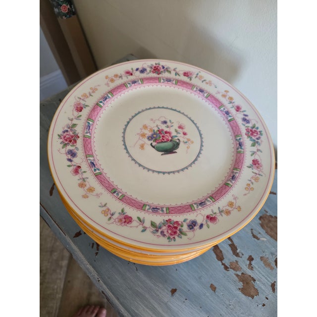 Set of 15 royal Doulton Urn Pattern Plates..these have a saffron colored detail around the outer edge perimeter which has...