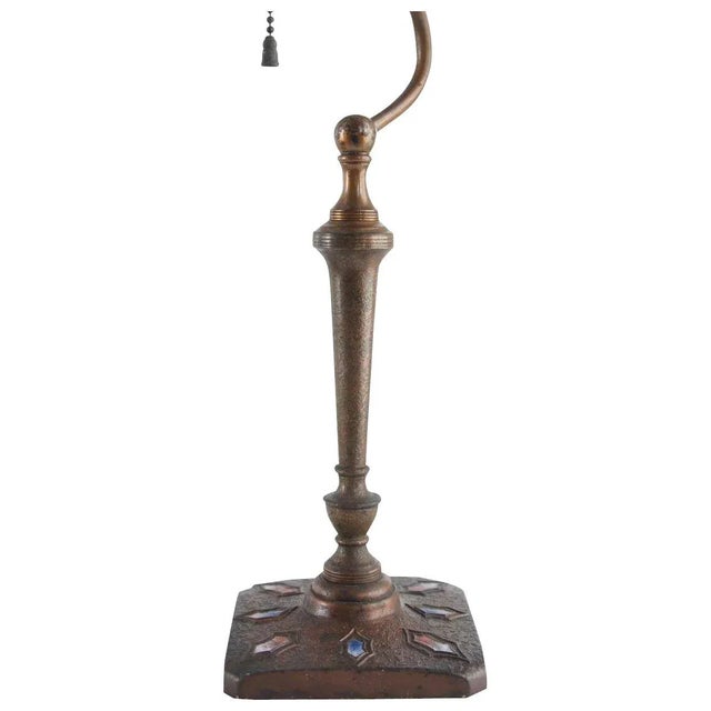 This vintage one-light, gooseneck table lamp by Nash displays a textured bronze finish with a square base decorated with...