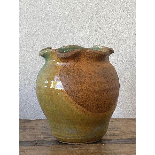 This vintage studio art pottery vase is a charming example of organic modernism, showcasing the expressive beauty of hand-...