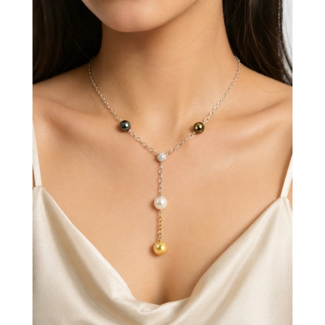 Stunning 18K white gold pendant necklace featuring 4 Tahitian pearls white, yellow, and 2 black with a diamond sphere...