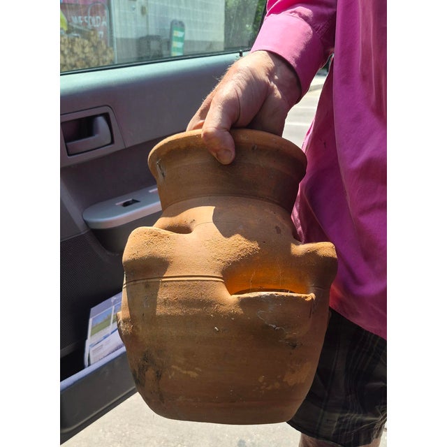 hand-turned terracotta strawberry planter jar, traditionally crafted from regional red clay. These unique garden vessels...