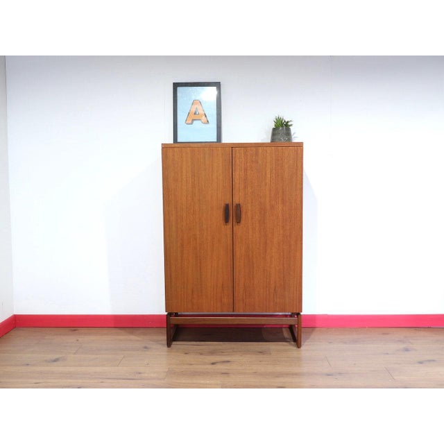 A beautiful compact armoire by renowned furniture maker G Plan, as part of their Quadrille range, this vintage teak...