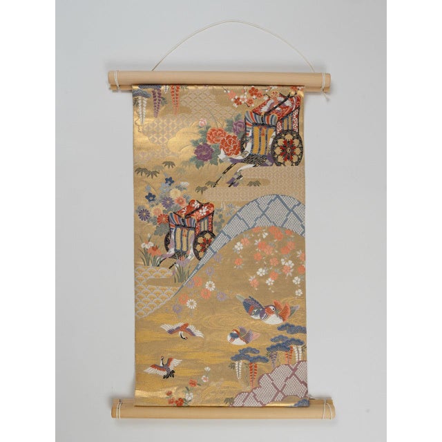 Four auspicious motifs. One Nishijin gold ground. Woven once in Kyoto. The Oshidori-Goshoguruma is a wall tapestry mounted...