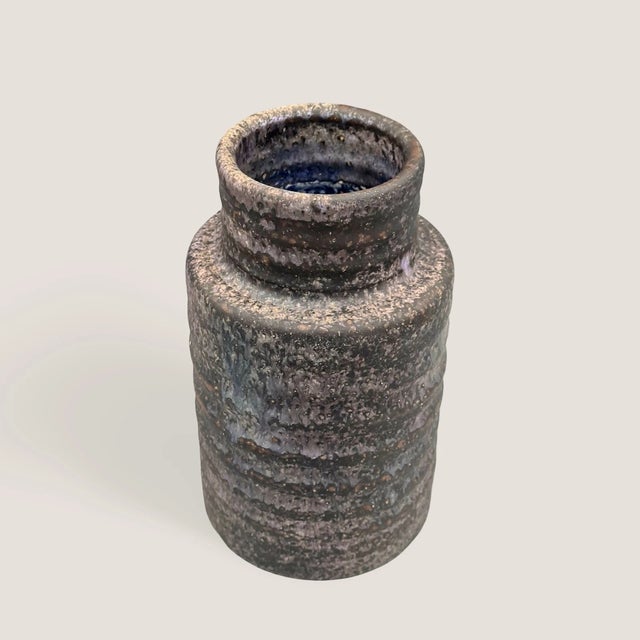 A distinctive studio ceramic vase by Mobach Keramik, Utrecht, from the 1960s. Its striking, horizontally grooved form and...