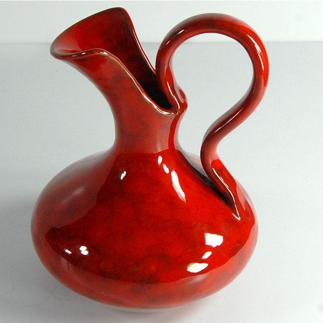 This decorative ceramic plate features a deep burgundy glaze. It comes from the Italian manufacturer Italika Ars, dating...