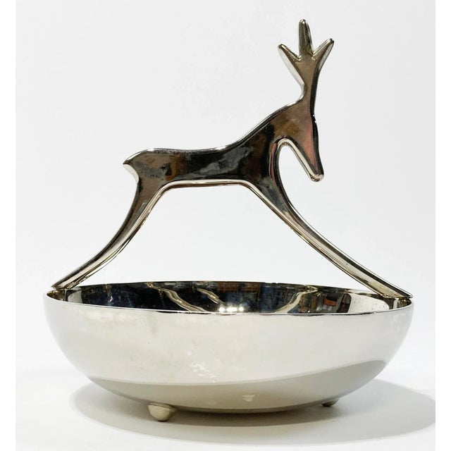 Vintage footed round silver plate candy or trinket dish featuring modern reindeer figure atop. Marked Made by Sheridan....