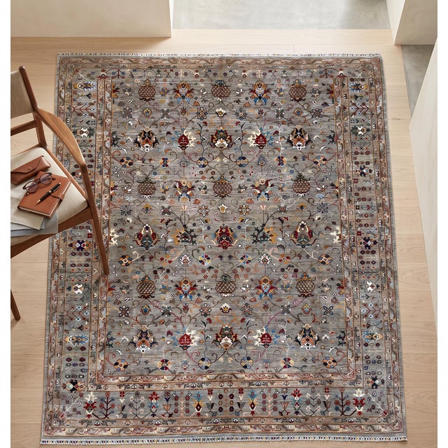 A hand-knotted Chobi area rug, woven in Afghanistan on a cool silver-grey ground with an allover pattern of pomegranates,...