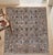 A hand-knotted Chobi area rug, woven in Afghanistan on a cool silver-grey ground with an allover pattern of pomegranates,...