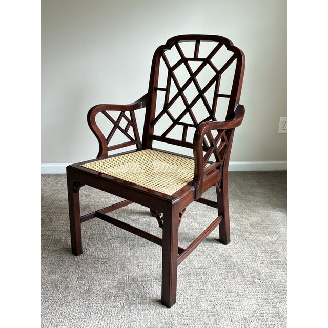 Elegant Anglo-Chinese style armchair featuring intricate geometric fretwork, rich mahogany-tone finish, and hand-caned...