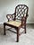 Elegant Anglo-Chinese style armchair featuring intricate geometric fretwork, rich mahogany-tone finish, and hand-caned...