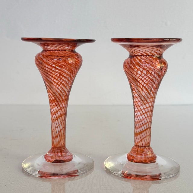 Rare midcentury hand-blown art glass candlestick holder pair in a warm pink-to-cranberry swirl. No maker’s mark allow us...